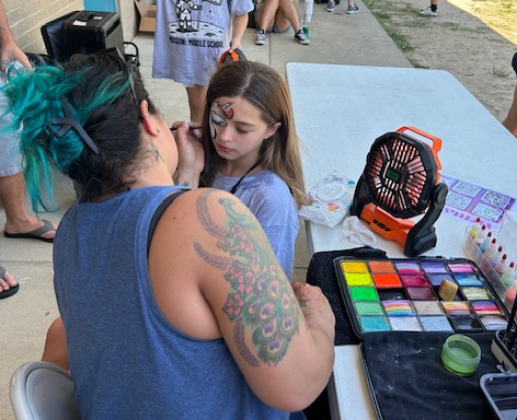 5th grade student getting their face painted  at field day