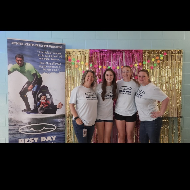 SCA members standing proudly in front of a backdrop 