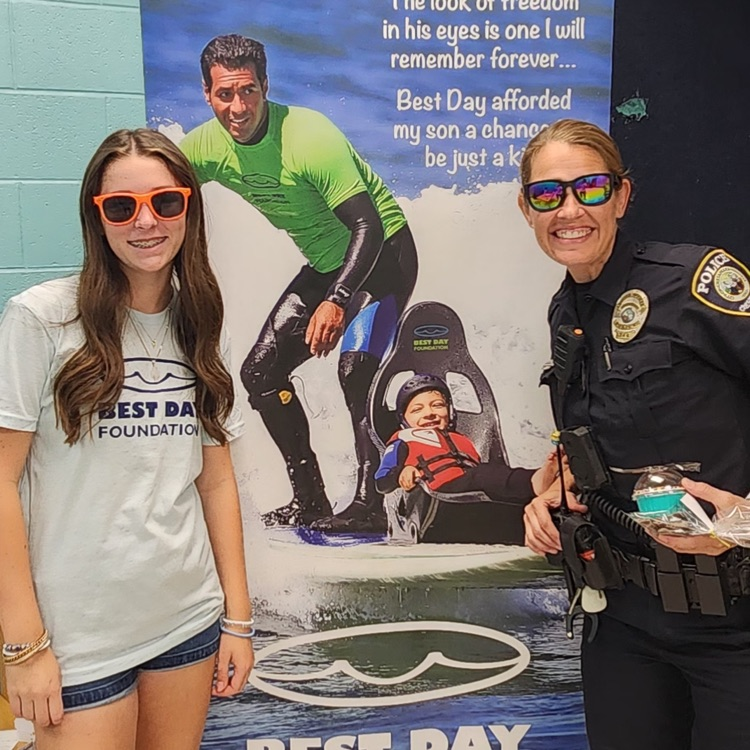 our security officer and student leader standing with Best Day banner