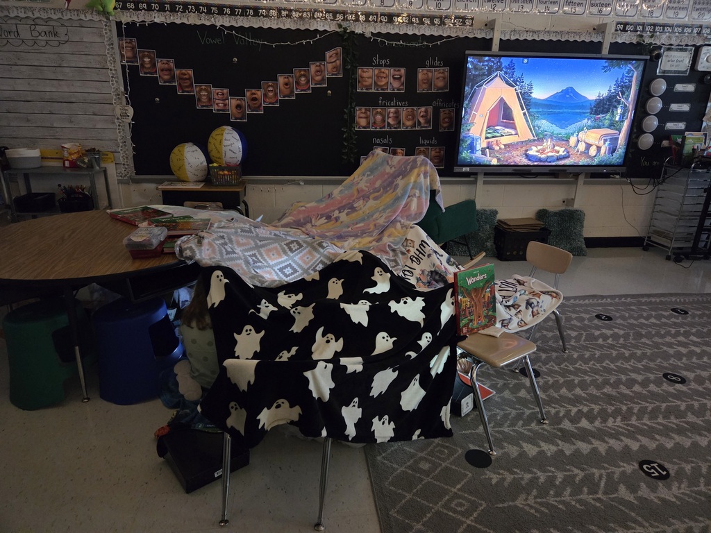 It was Campout Reading Day in Miss Stafford's class today. Students had fun building blanket tents to read in and they even got a special visit from Miss Stafford's mom who read them the story Curious George Goes Camping!