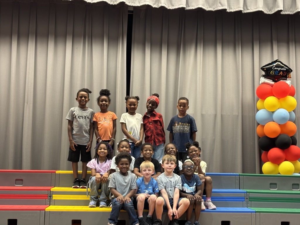kindergarten students on stage with balloons