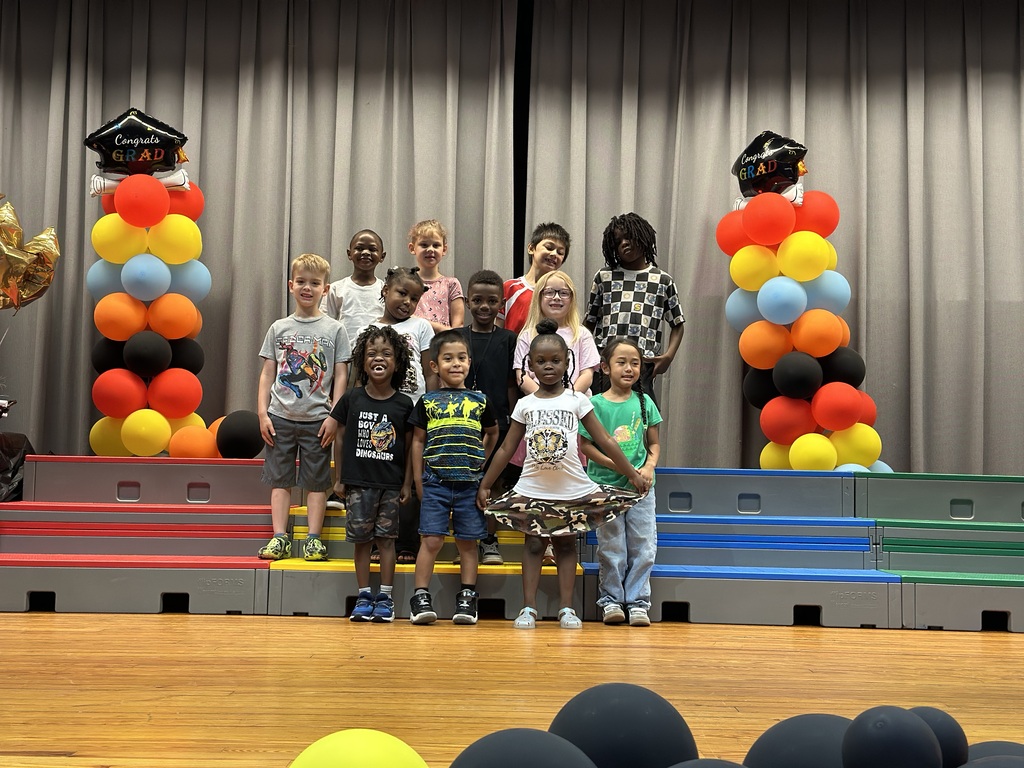 kindergarten students on stage with balloons