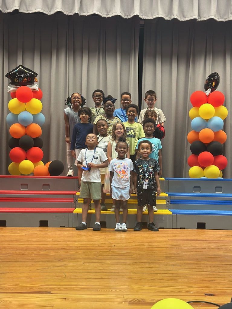 kindergarten students on stage with balloons