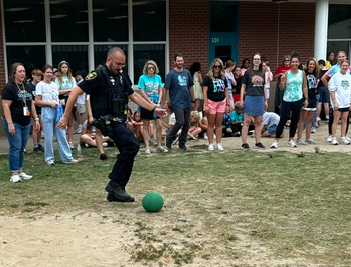 teacher kicking the ball