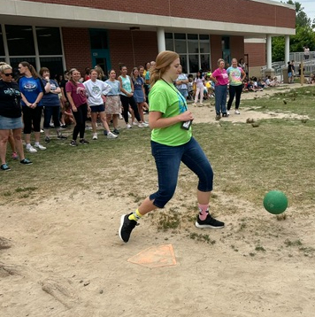 teacher kicking the ball