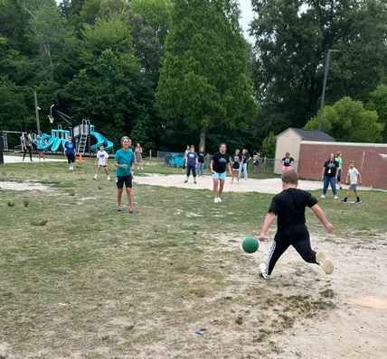 student kicking the ball
