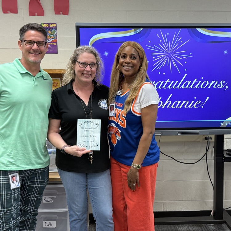 Mr. Triolet and Ms. Alexander with Mrs. Boyles smiling and holding her award plaque.