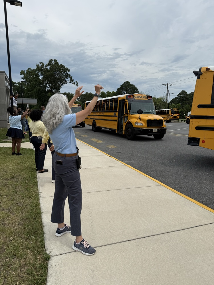 mrs. Outlaw waving goodbye to the students!