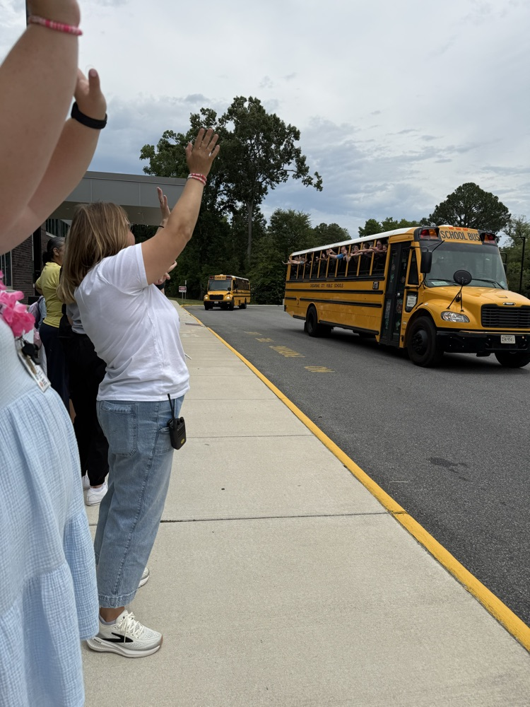 Teachers lined up waving goodbye to the student