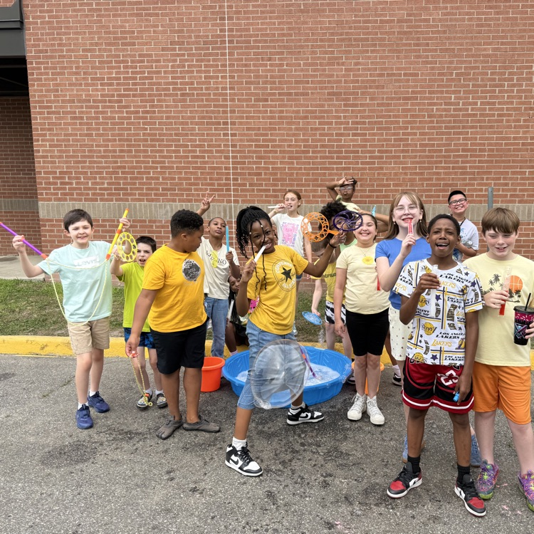 Group of students at field day bubble station. 