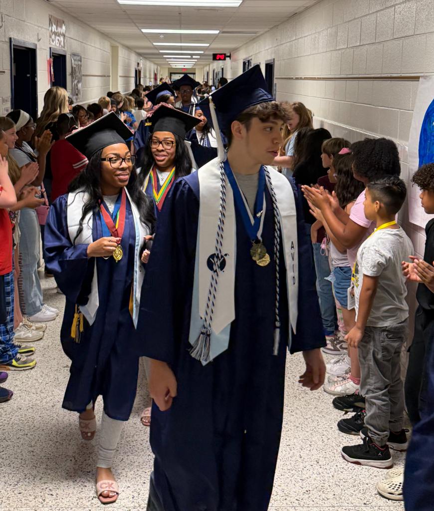 IRH students walking down the halls with SRI students cheering them on.