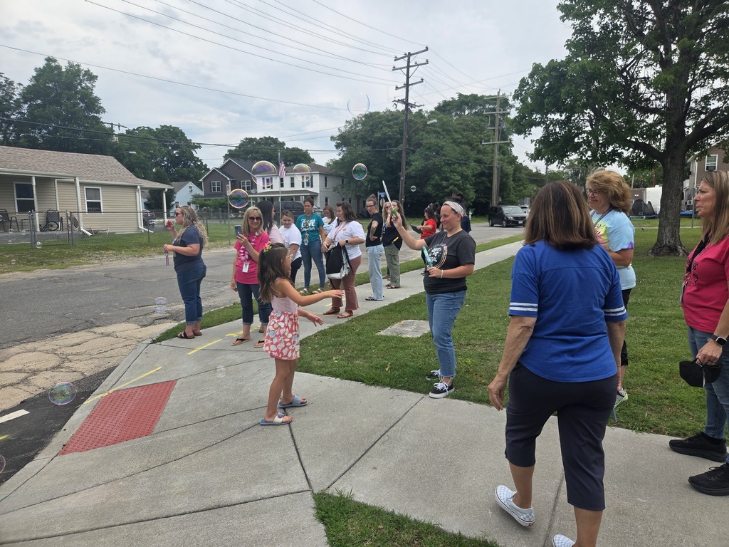 Teachers waving goodbye to the students