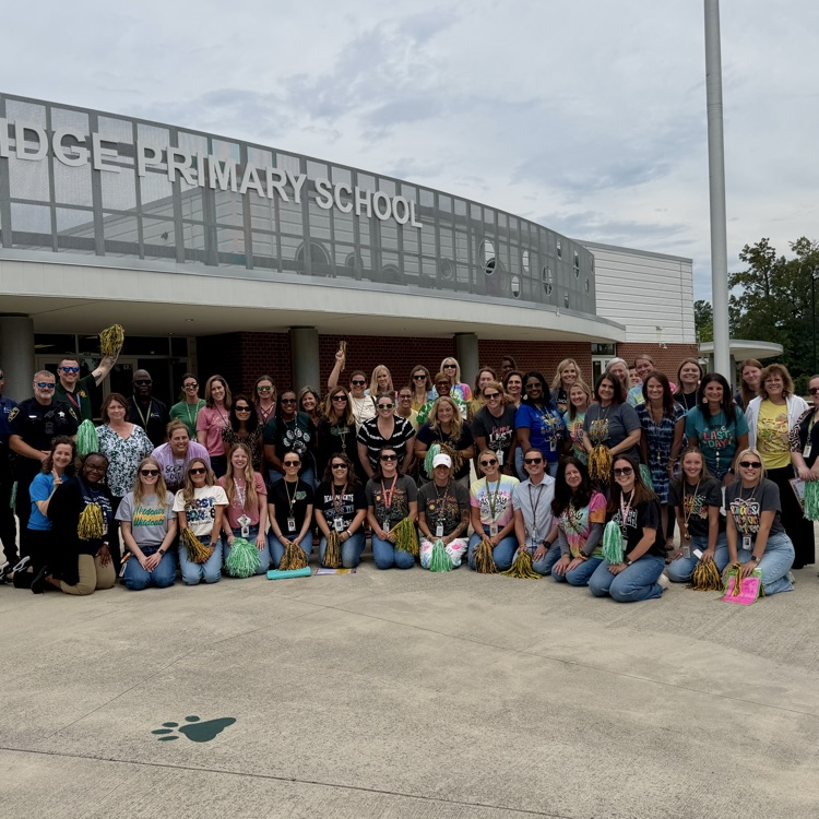 GBP staff gathered around, posing excitedly after waving good bye to students for the last time this school year