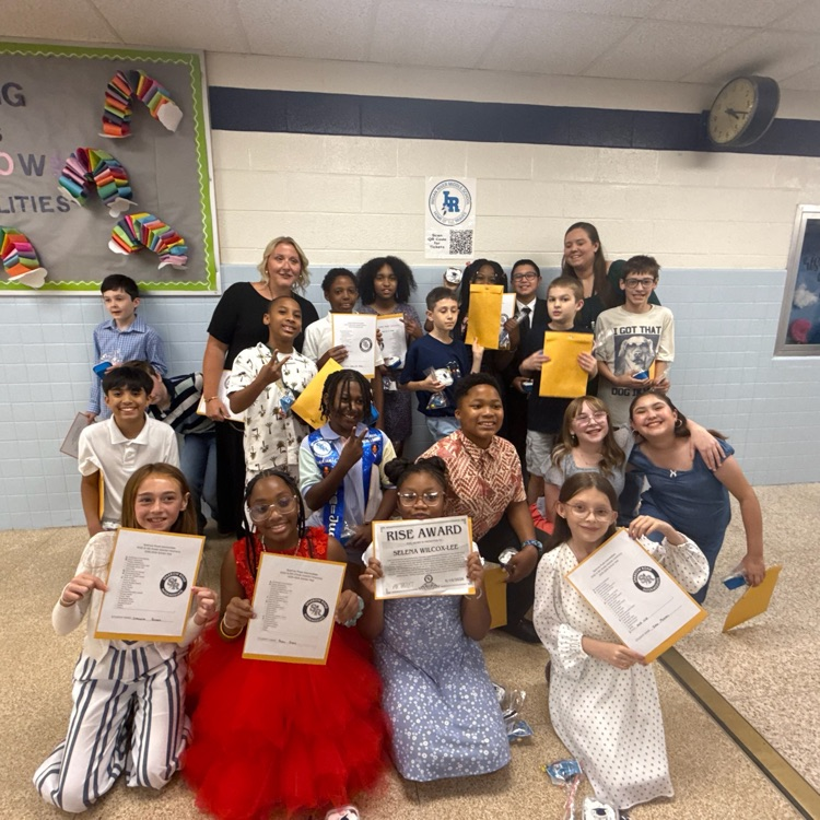 Ms. Warner and Mrs. Brittingham’s class holding up certificates.