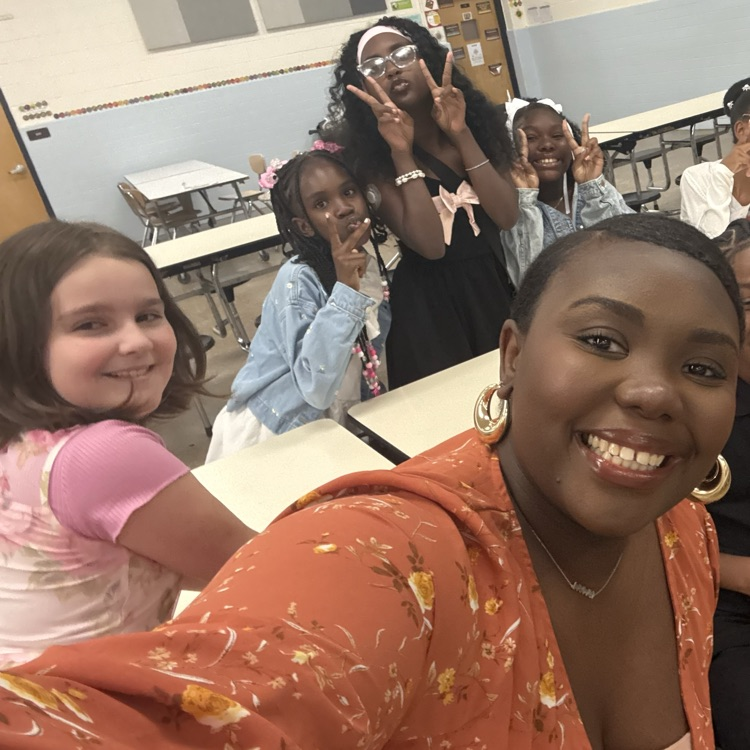 Selfie with students and teacher smiling. 