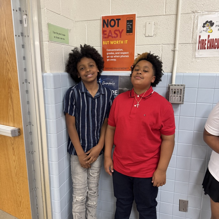 Two students smiling as they wait to be announced. 