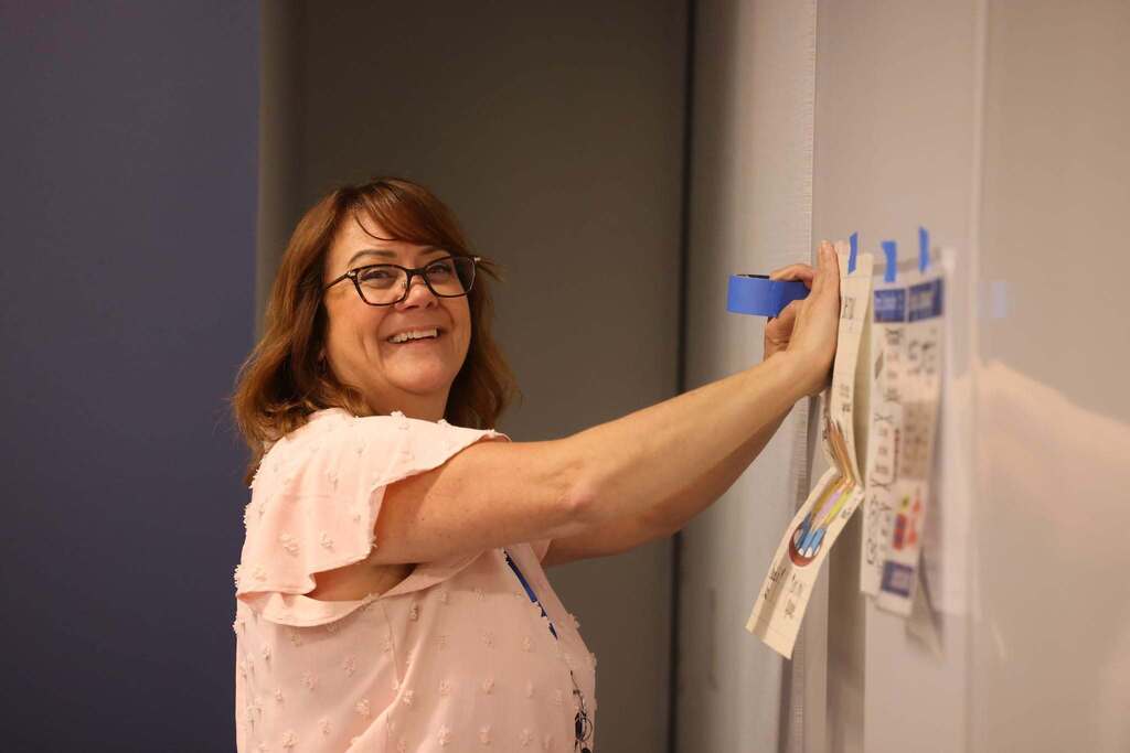Educator setting up a room for the conference.