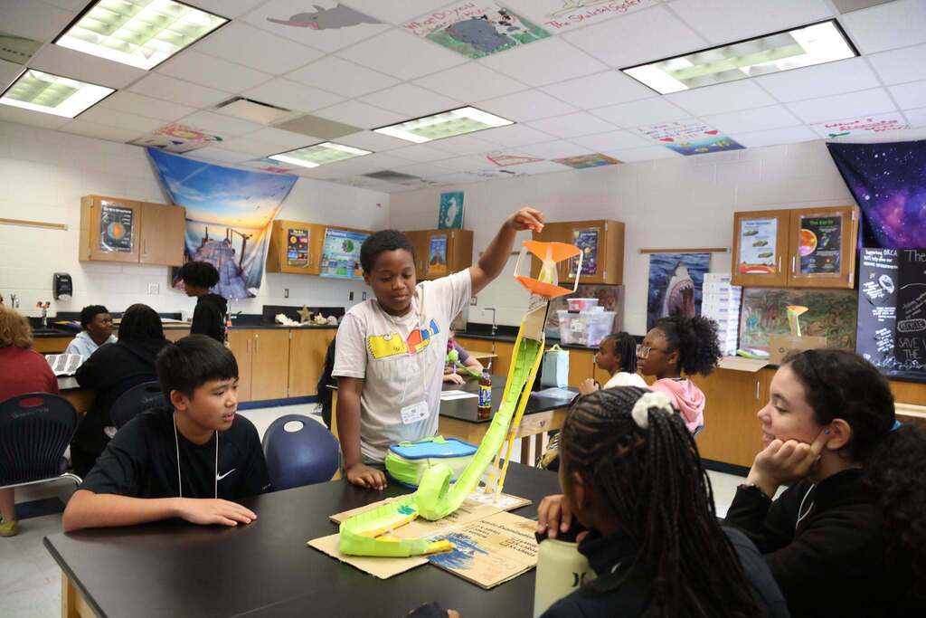 students test out their rollercoaster creation with smiles