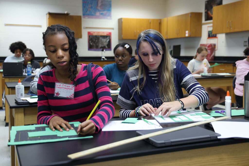 students create little towns with paper and they are focused on the task