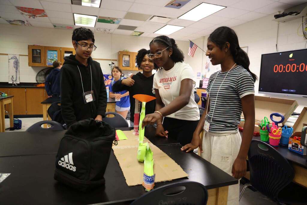 students test out their rollercoaster creation with smiles