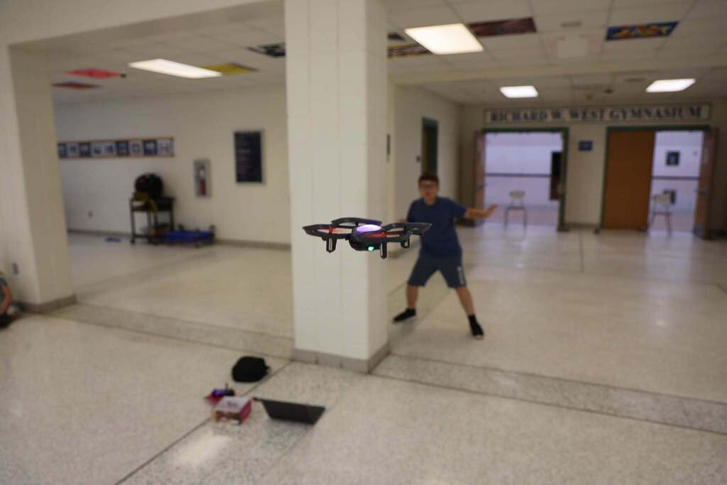 Student excitedly watches drone flying