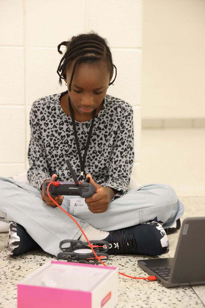 student excitedly plays with drone at CTE camp