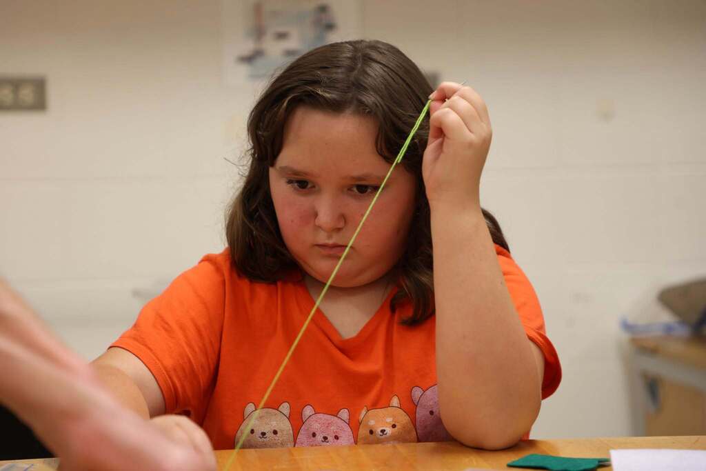 studnnt focused on sewing