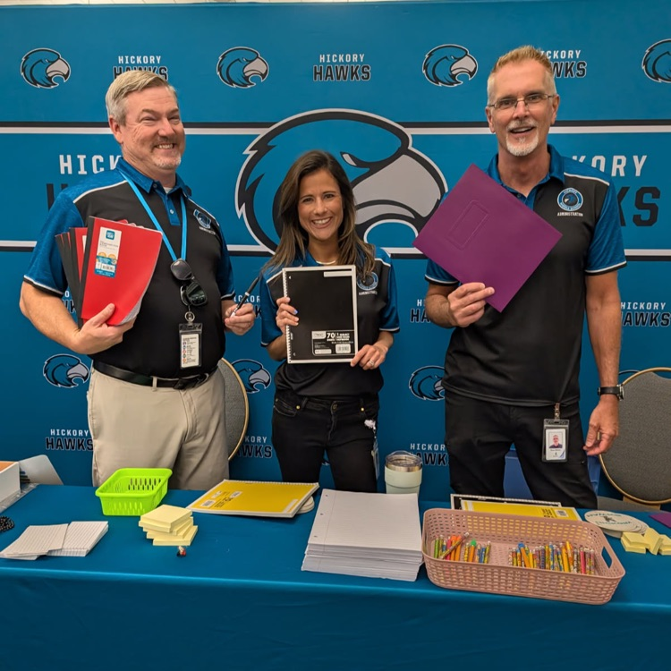 Our admin team smiling with school supplies at a district wide event