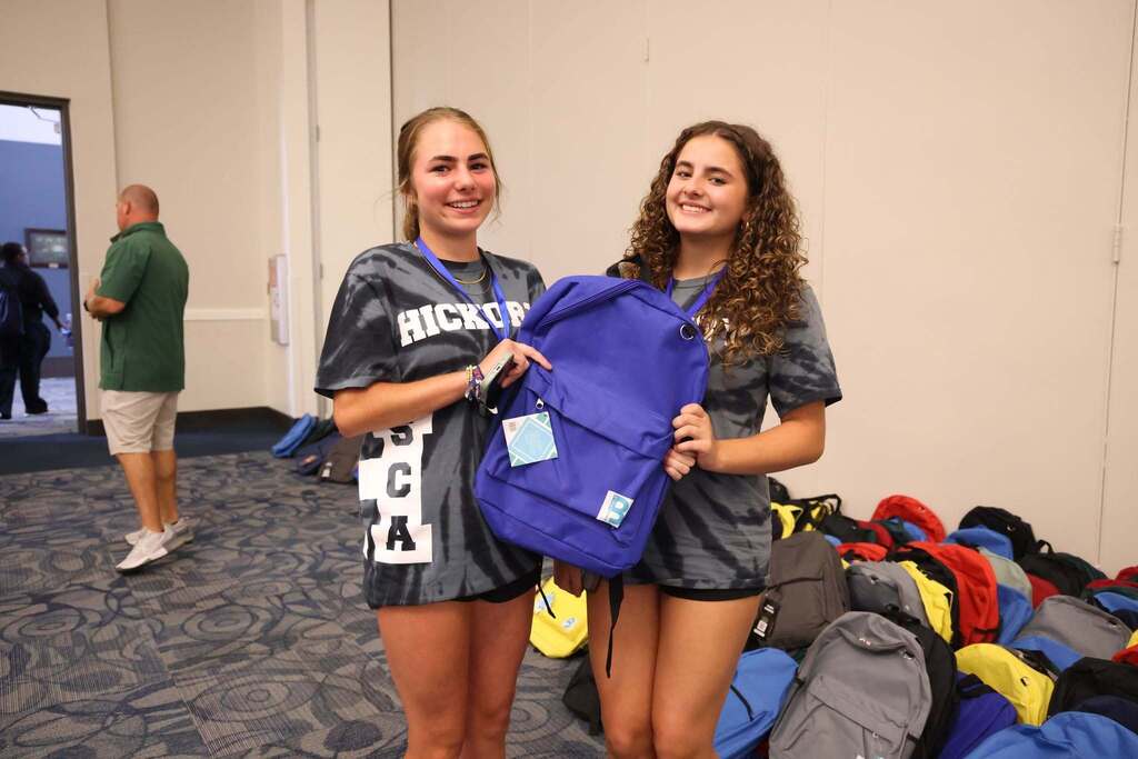 two teenagers showing off backback
