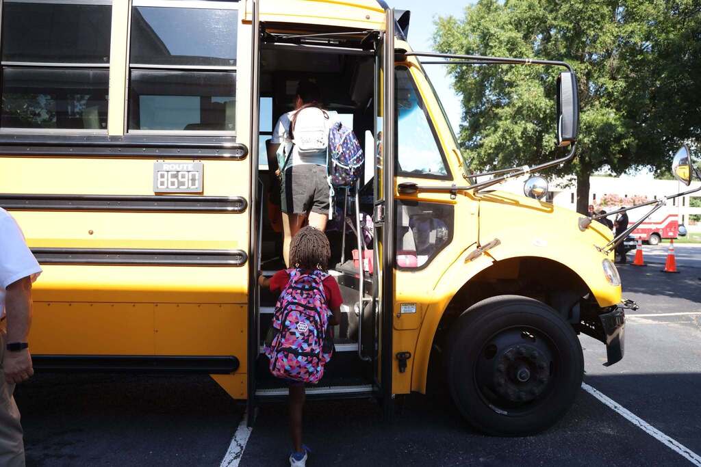students test out the bus by climbing on