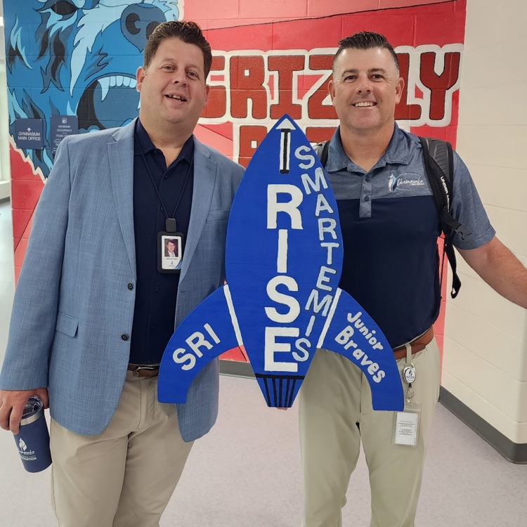 More staff smiling and holding Smartemis rocket cutout. 