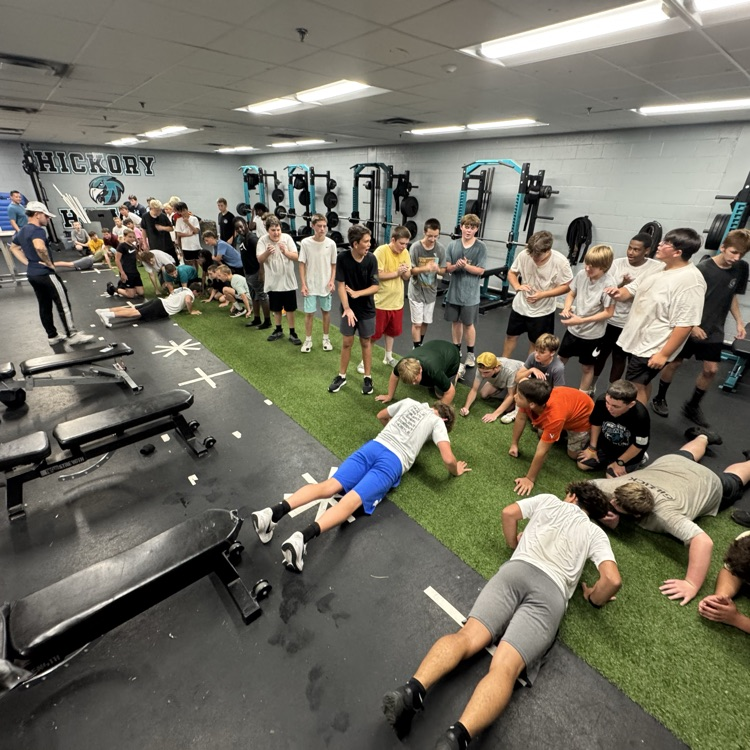 football players working hard in the weight room