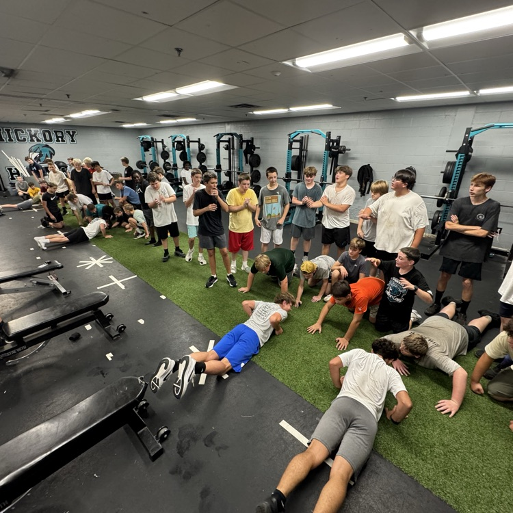 football players working hard in the weight room