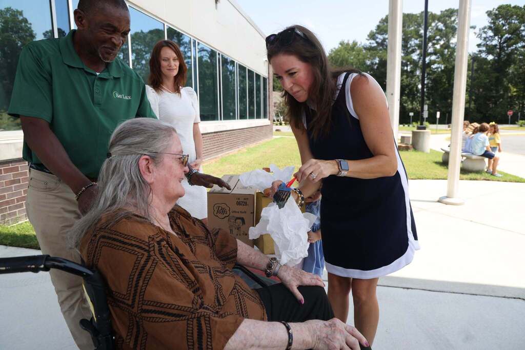 Ms. Chittum smiles as she receives gift