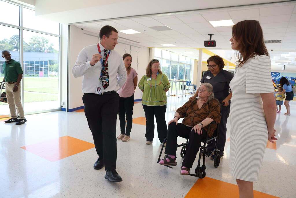Ms Chittum listens as she tours the school