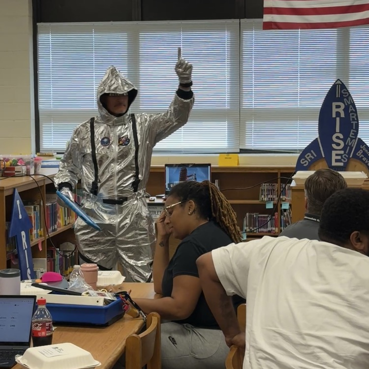 Mr. Triolet presenting to the staff in his space suit