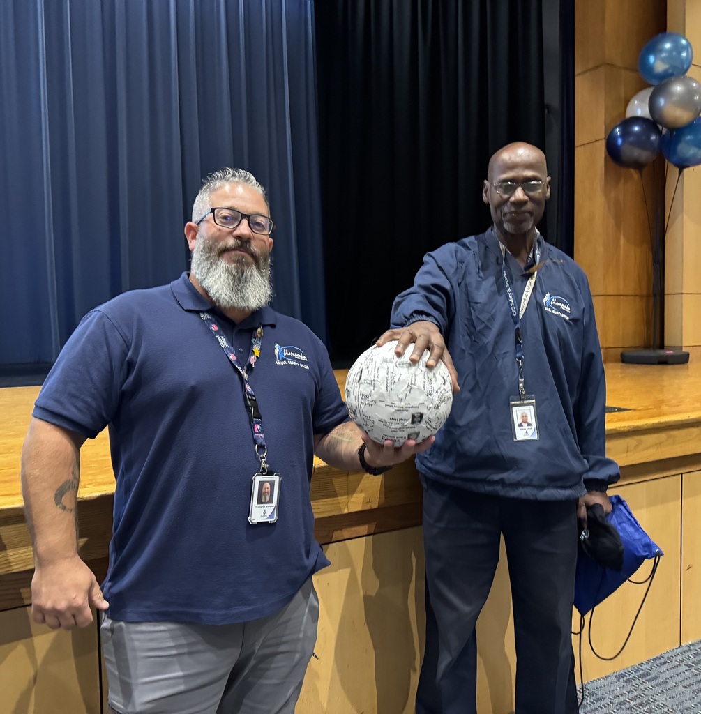 Mr. Brohamer and Mr. Elliott pose with winning badge ball