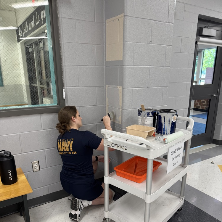 military volunteer painting the main office