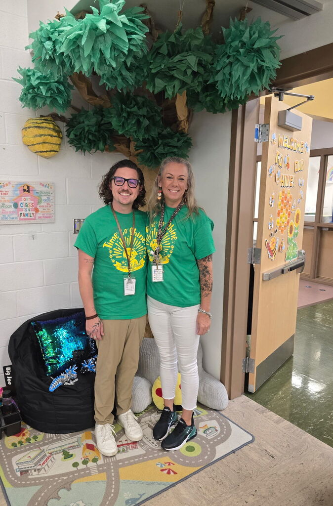 Mrs. Scott and Mr. Swafford posing and excitedly waiting to meet students at Meet and Greet