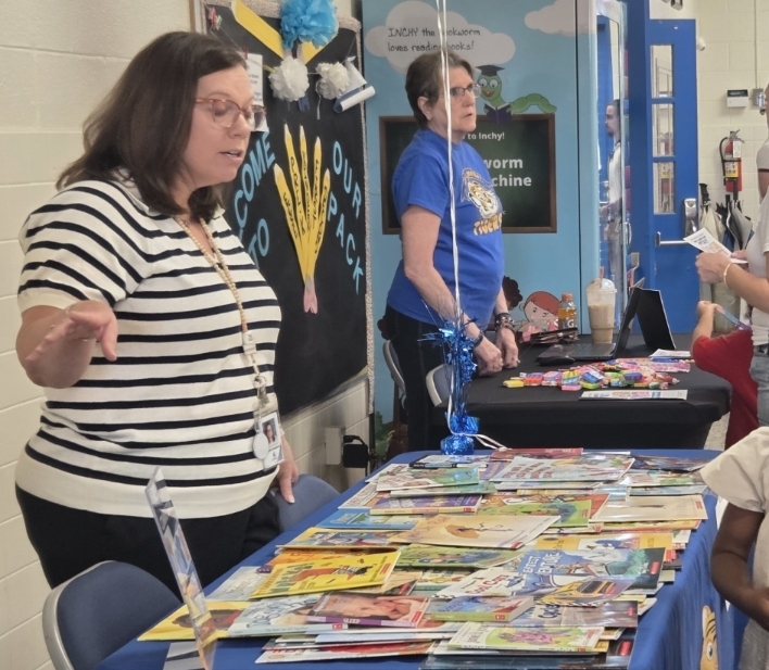 Mrs. Stradman giving out books