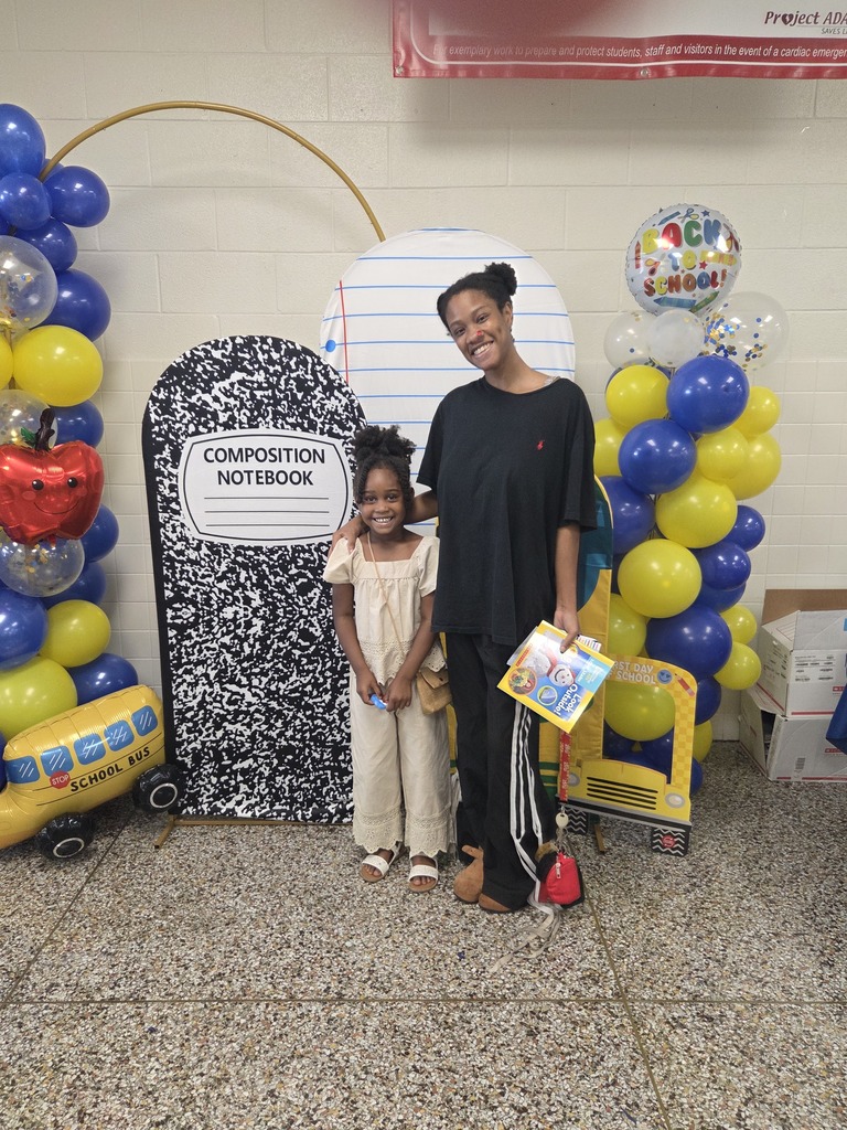 Student and family member with school backdrop