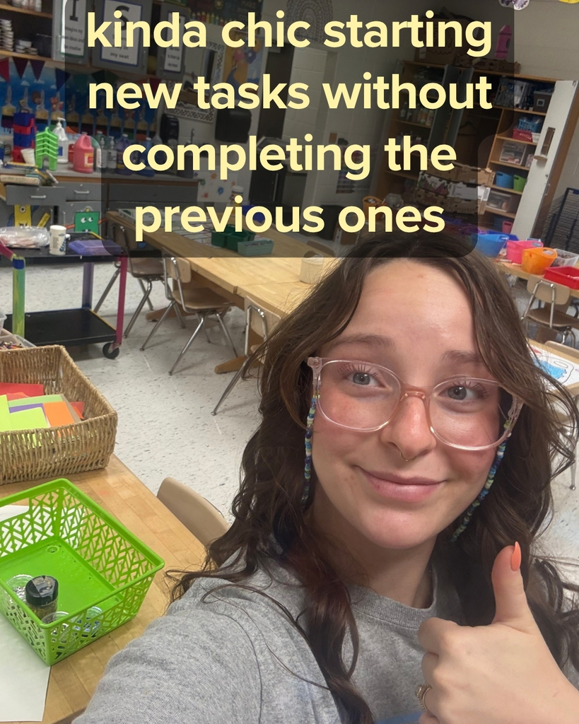Mrs. Davis giving a thumbs up in her art classroom - Kinda chic starting new tasks without completing the previous ones