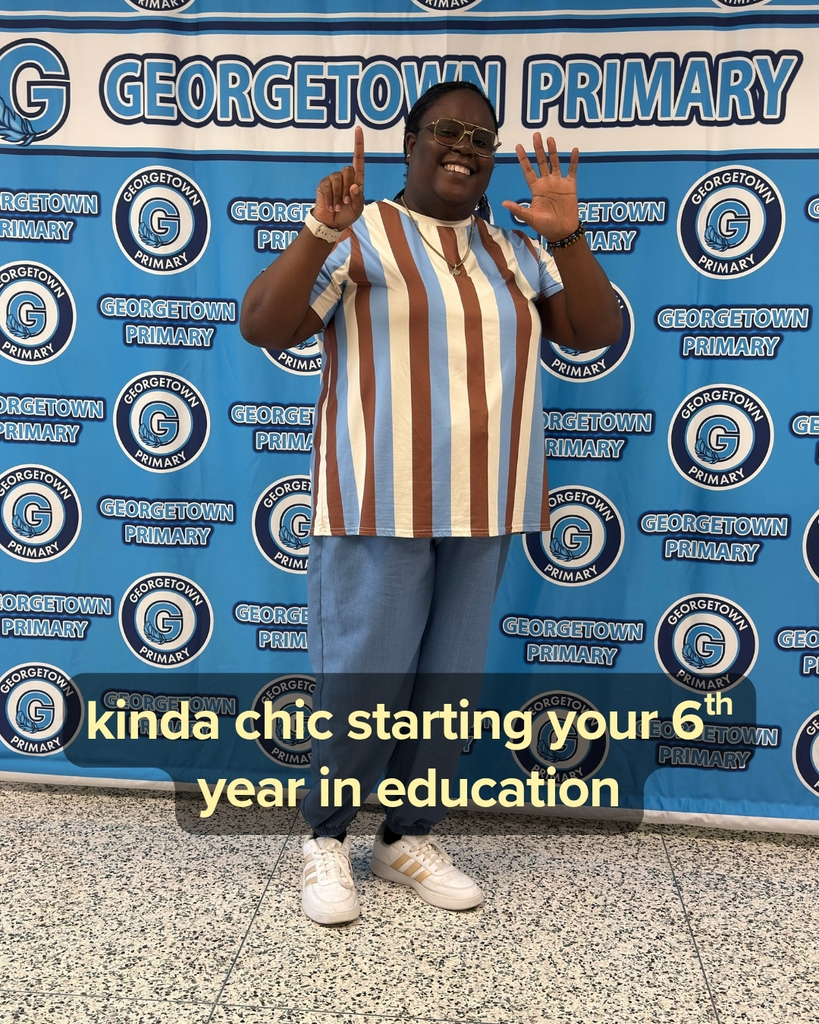 Ms. Williams posing holding up 6 fingers - kinda chic starting your 6th year in education