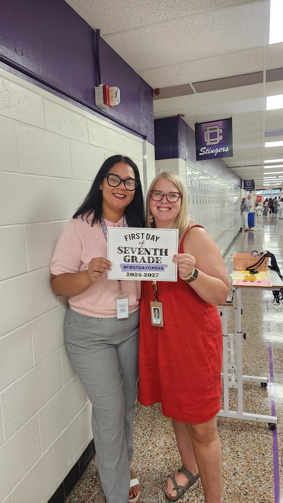 Teachers Holding up first day cps sign
