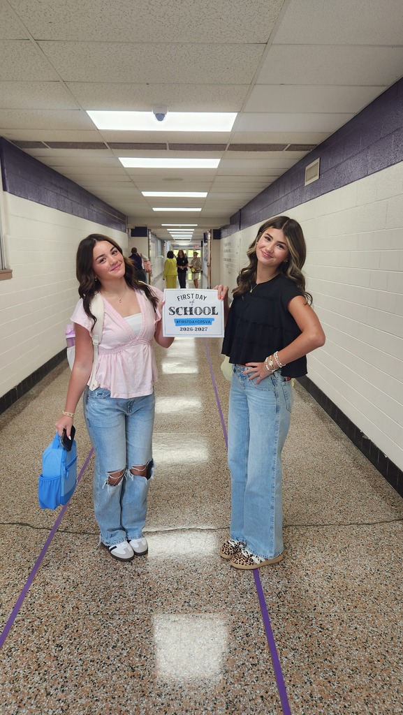Students holding up the first day cps sign.