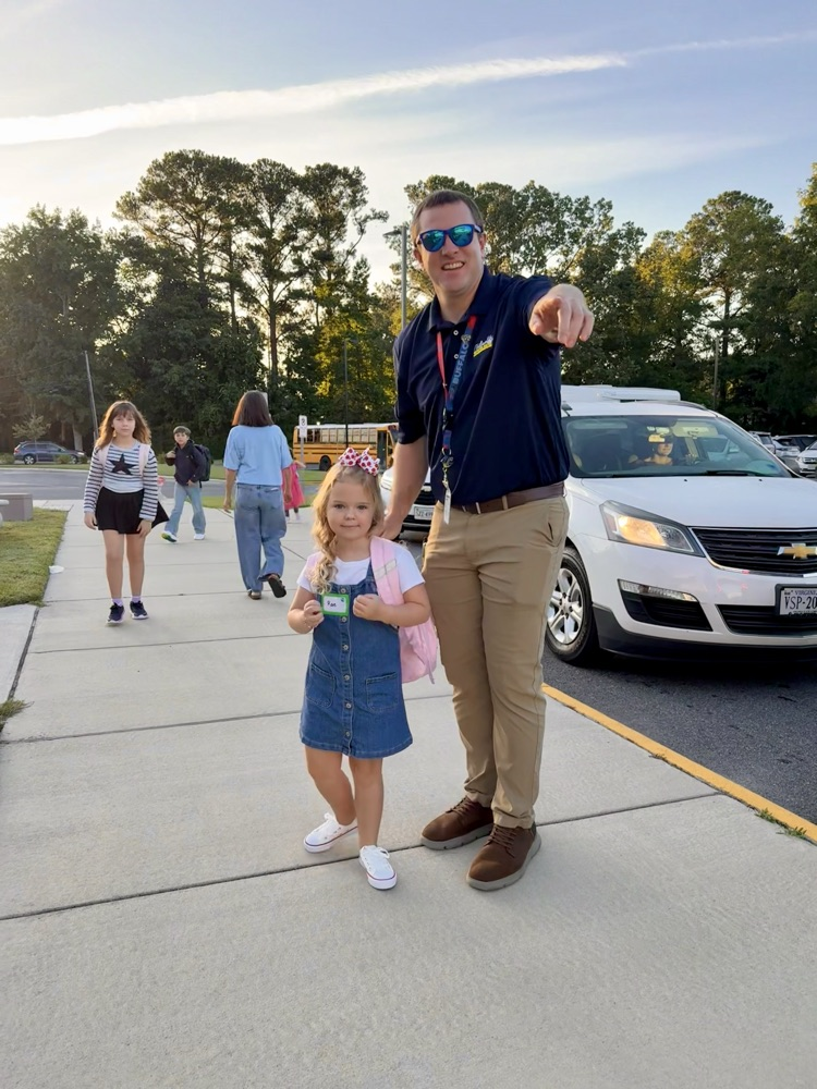 first day of school principal with student at parent drop off