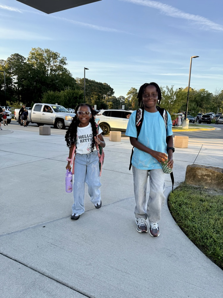 Parent drop off students walking into school