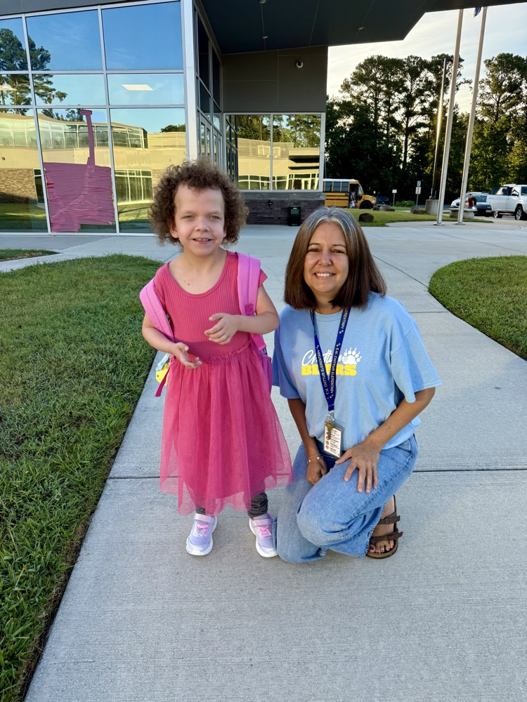 Student and teacher smiling at the first day of school