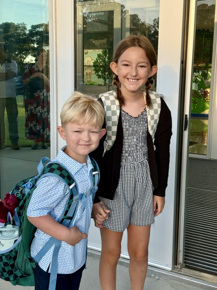 Siblings, smiling for the first day of school