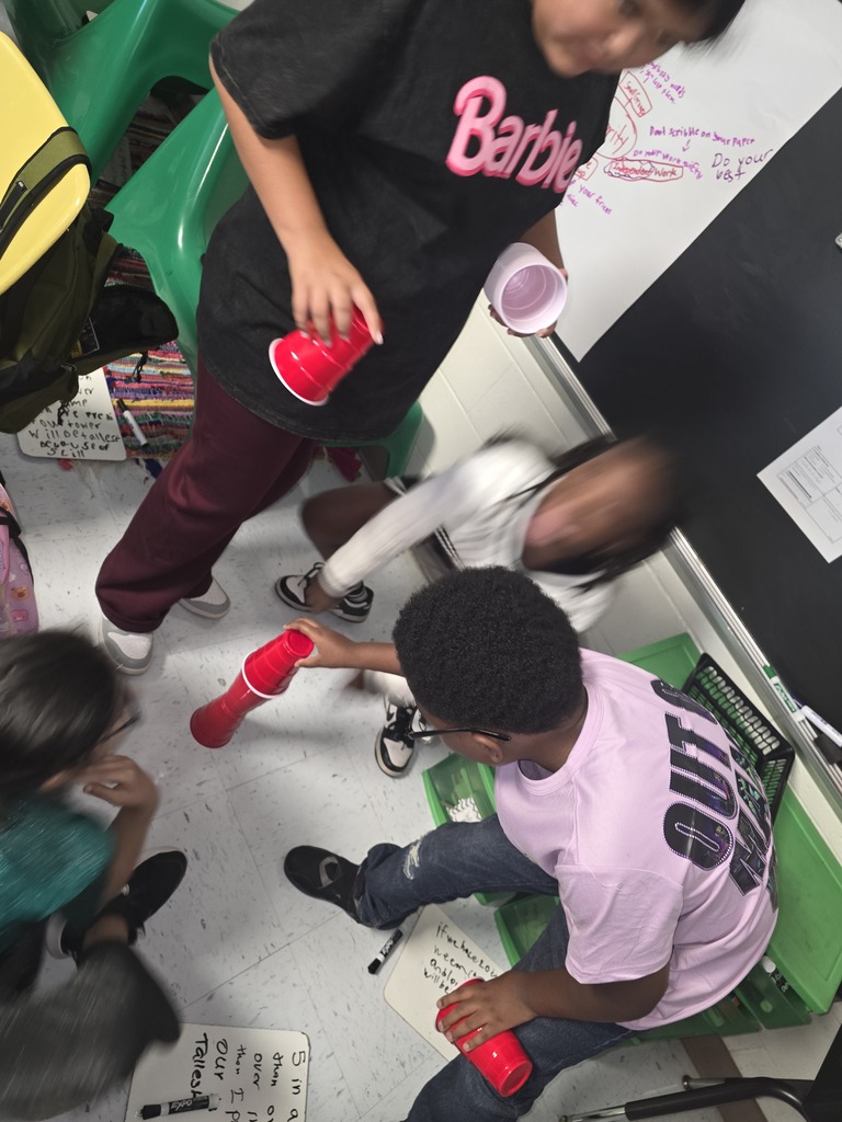 Kids building cup towers